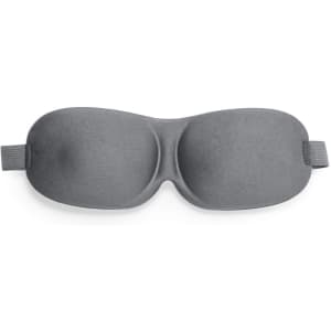 A grey travel eye mask with a smooth texture and adjustable straps, featuring a simple design and branding.