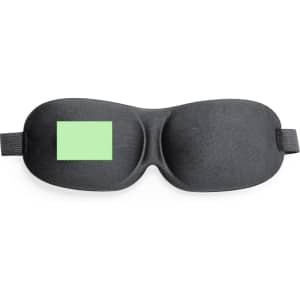 A black travel eye mask with a green accent and an adjustable strap. It features a logo.