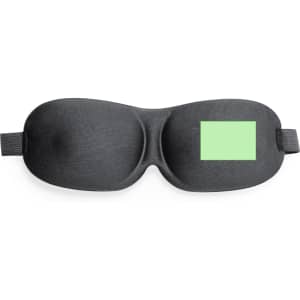 A black travel eye mask with a green panel, featuring a logo on the side.