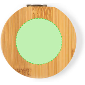 A circular bamboo sewing kit with a green fabric centre, featuring a clasp for secure closure.