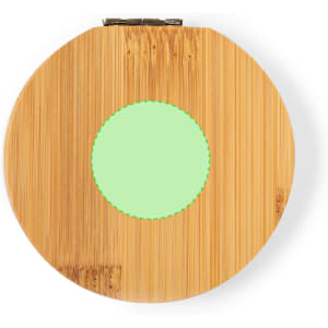 A circular bamboo sewing kit with a green centre, featuring a clasp for secure closure.