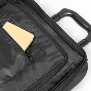 A black wheeled bag featuring a smooth exterior, with a zipper pocket containing a yellow item inside.