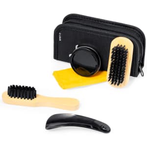 A shoe cleaning set featuring a black storage case, wooden brushes, a cleaning solution, and a black shoehorn.