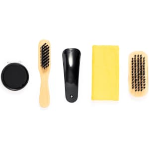 A shoe cleaning set featuring a black container, wooden brushes, a horn, and a yellow cloth.