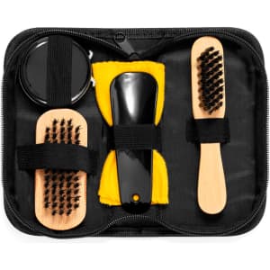A shoe cleaning set featuring a black container, two brushes with wooden handles, and a yellow cloth in a zippered case.