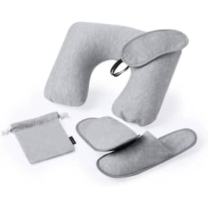 A grey travel set featuring a neck pillow, eye mask, and slippers, all stored in a matching bag with a logo.