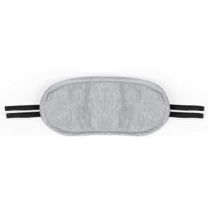 A grey sleep mask with black elastic straps, designed for comfortable wear during travel or relaxation.