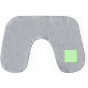 A grey travel pillow with a unique cut-out design and a small green patch on the side.