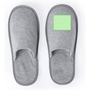 A pair of grey spa slippers featuring a blank area for custom branding or design. Soft fabric and open-toe style.