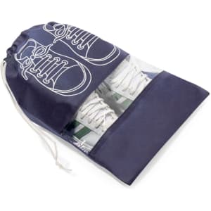 A navy drawstring shoe bag with a clear front displaying white sneakers and a logo.