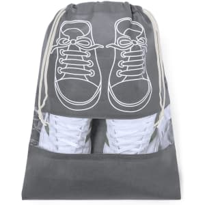 A grey shoe bag with a drawstring closure and a transparent bottom, featuring a graphic of sneakers on the front.