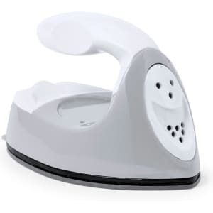 A compact grey and white iron with a smiling face design on the front and a handle for easy grip.