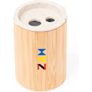 A pencil sharpener in a cylindrical bamboo body with a light-coloured top and a logo in vibrant colours.