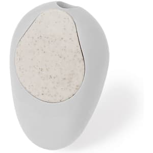 A grey pencil sharpener with a textured light grey section, featuring a round design and a small opening on top.