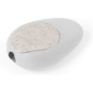 A grey pencil sharpener shaped like a smooth stone, featuring a speckled light grey top and a small opening.