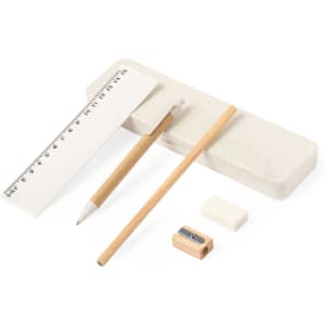 A beige stationery set including a ruler, a pencil, an eraser, and a sharpener on a light surface.
