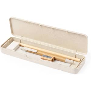 A writing set in a beige case, featuring a pencil, eraser, sharpener, and an additional writing tool.