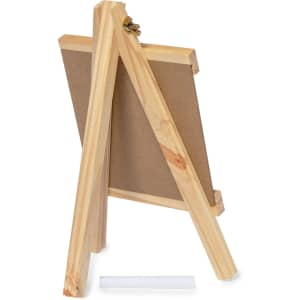 A wooden easel with a blank board, featuring a chalk holder and a piece of chalk at the base.