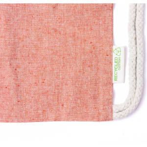 A drawstring bag in a soft coral colour, featuring a natural rope drawstring and a recycled cotton label.
