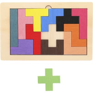 A wooden puzzle with various coloured pieces, including green, arranged in geometric shapes on a light wooden base.