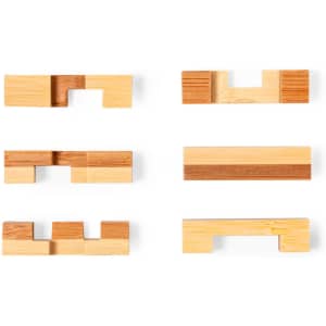 A set of wooden puzzle pieces in various shapes and shades of beige and brown. The pieces are arranged in two rows.