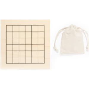 A wooden Sudoku board with a blank grid and a small beige cotton pouch beside it.