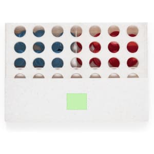 A box containing red, white, and blue game pieces, featuring circular holes and a logo on the packaging.