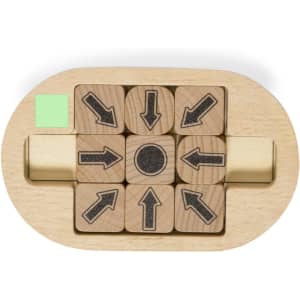 A wooden mini puzzle featuring nine directional arrows and a central circle, set in a light wood base with a green corner.