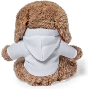 A plush teddy bear in brown with floppy ears, wearing a white hoodie. The teddy sits upright, facing away.