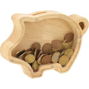 A wooden piggy bank in a pig shape, featuring coins inside and a small slot for inserting money.