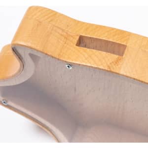 A wooden money box with a smooth, light-coloured finish and a slot for coins. It features a simple, natural design.