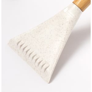 A white ice scraper with a textured edge and a wooden handle, featuring a logo.