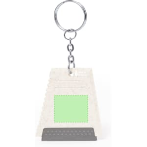 A green Ucko ice scraper keyring featuring a textured scraping edge and a metal keychain attachment.
