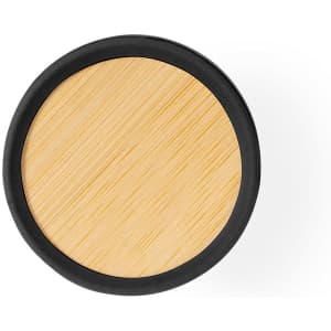 A round air freshener with a bamboo top and a black base. It features a smooth, natural finish.