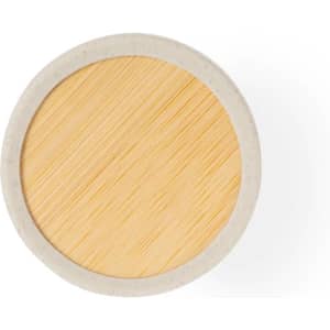 A round air freshener in beige and light wood colour with a textured surface. It features a simple design and a branding logo.