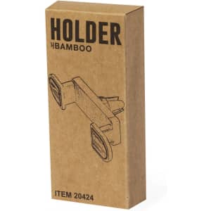 A bamboo phone holder in a cardboard box, featuring a simple design and two grips for secure placement.