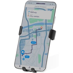 A smartphone mounted in a black car phone holder, displaying a map with transport options and route details.