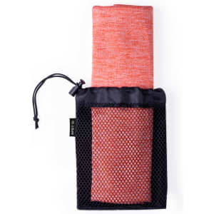 An absorbent towel in vibrant coral, rolled up and stored in a black mesh pouch, featuring a drawstring closure.
