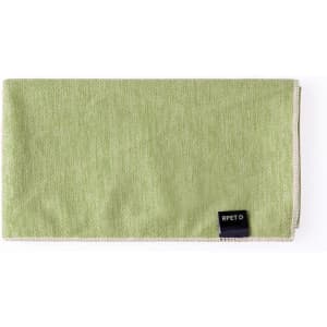 A green absorbent towel with a stitched edge and a logo tag. Ideal for leisure and outdoor activities.