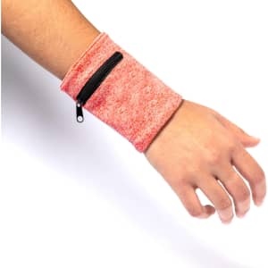 A pink wristband with a zippered pocket, worn on a wrist. The design features a textured surface.