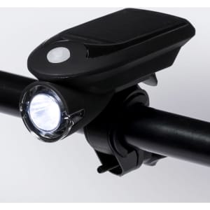 A black bike safety light mounted on a black handlebar, featuring a white LED light and a solar panel.