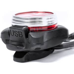 A red and black USB bike safety light with a mounting bracket for attachment.