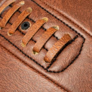 A brown leather ball featuring stitched detailing and a textured surface. It has a logo on the side.