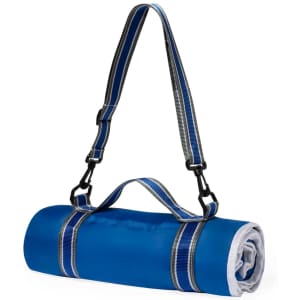 A blue picnic blanket rolled up with a handle and adjustable strap. It features a secure fastening and a contrasting lining.
