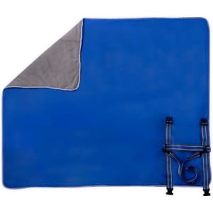 A blue picnic blanket with a grey underside, featuring straps for easy carrying. It has a branded logo.