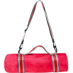 A bright pink picnic blanket rolled up with a carrying strap and a logo.