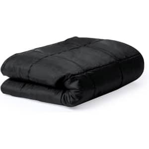 A black picnic blanket, neatly folded, featuring a quilted design and a smooth fabric texture.