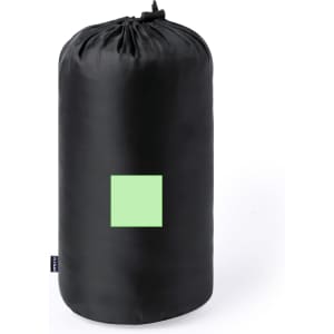 A black picnic blanket rolled up in a cylindrical shape, featuring a small green square. It has a logo on the side.