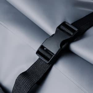 A grey dry bag with a black buckle strap, featuring a simple design and durable material.