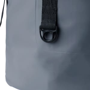 A grey dry bag featuring a textured strap and a clip closure detail. It has a minimalist design with a logo.